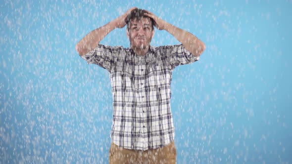 Man Scratches His Head on a Blue Background Dandruff Problem