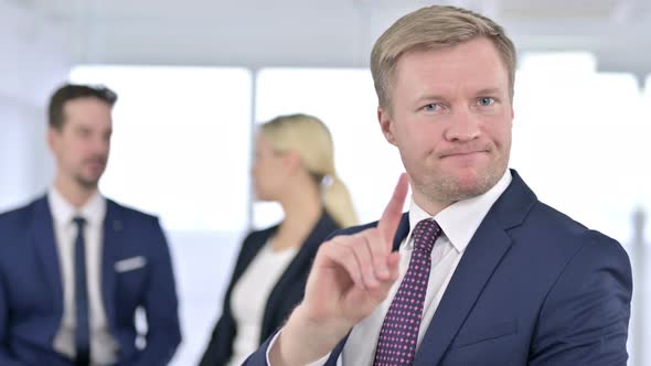 Portrait of Serious Businessman Saying No By Finger Sign