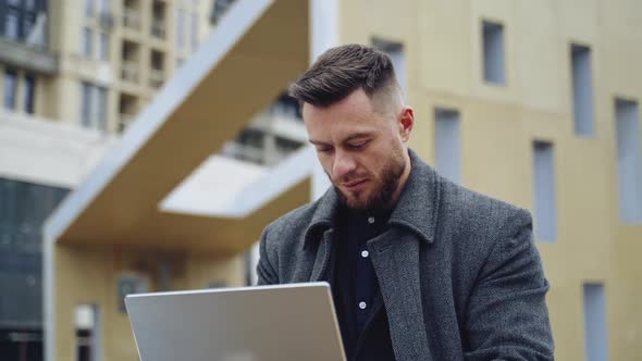 Portrait of a positive man with a laptop. 