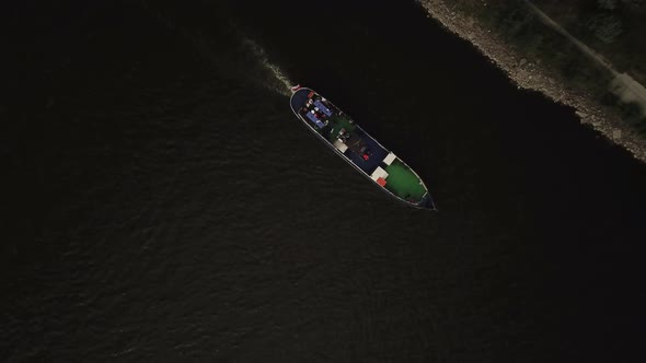 Video footage taken from bird's eye view by drone of floating cruise boat. View from the top to the
