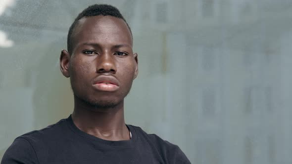 Proud American African young man turning and staring at camera.ethnic pride