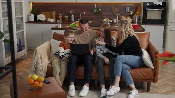 Joyful Deafmute Family Watching Video at Laptop