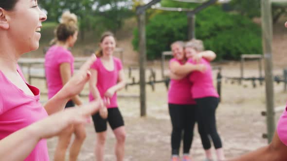 Happy Caucasian women embracing each other at boot camp