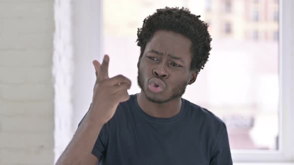 Portrait of Young African American Man Saying No By Hand Gesture