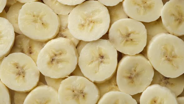 sliced banana top view rotation, pieces of the most popular banana fruit