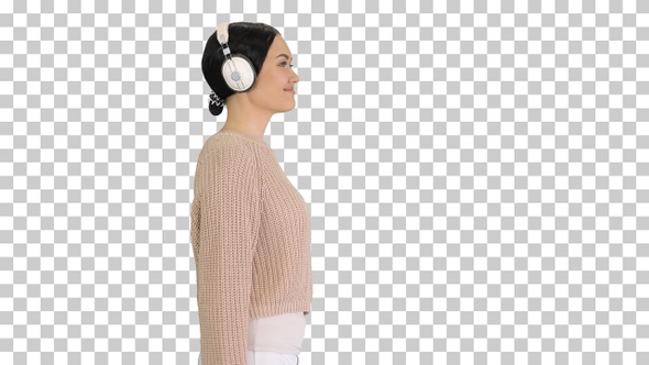 Young woman with headphones walking listening, Alpha Channel