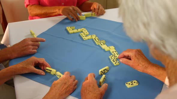 Senior friends playing dominos