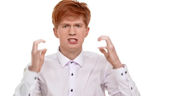 Angry Young Redhead Caucasian Man Standing on White Background Ready to Fight in Slowmotion