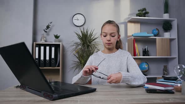 Teen Girl which Putting on Her Glasses Before the Beginning of the Work with Laptop