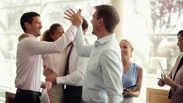 Business associates congratulating each other