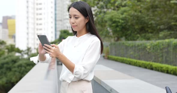 Young Woman use of smart phone in city