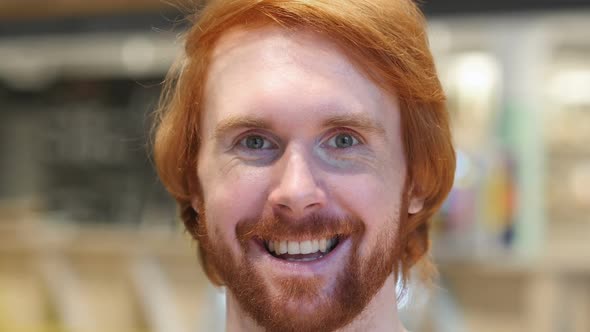 Face Close Up of Smiling Redhead Beard Man Looking at Camera