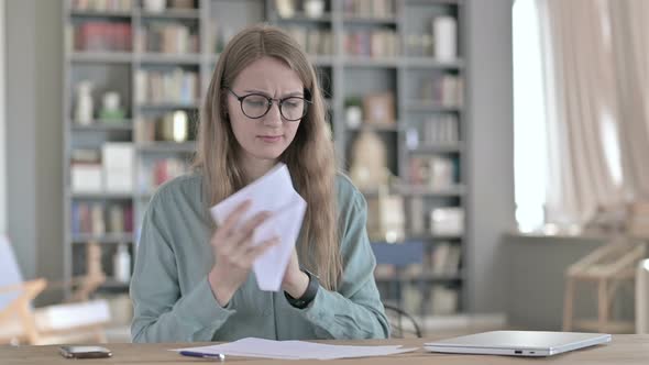 Hardworking Young Woman Thinking and Writing on Paper