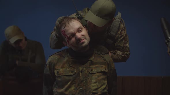 Portrait of Prisoner of War in Camouflage During Interrogation Indoors