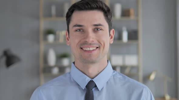 Portrait of Smiling Young Man Looking at Camera