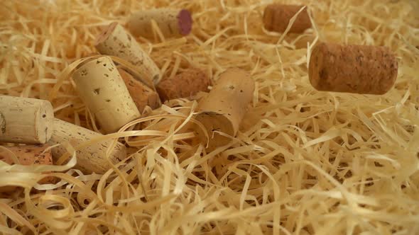 Falling wine corks on straw. Slow motion.