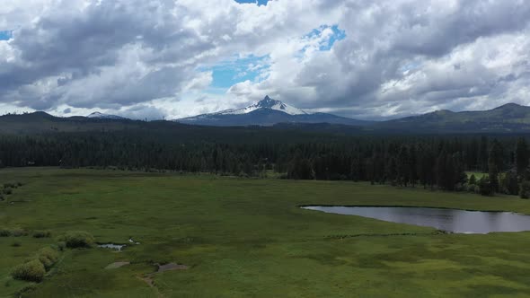 Aerial flying toward Mt. Washington in the Cascade Mountain Range in Oregon during summer.