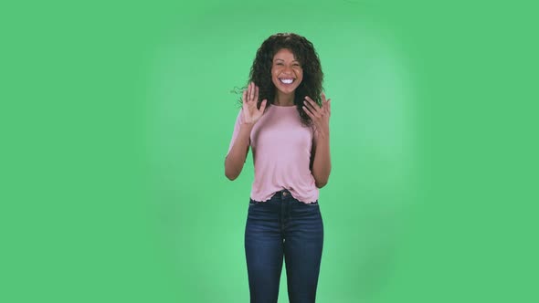 Portrait of Beautiful African American Young Woman Is Looking at Camera and Dancing Funny. Burning