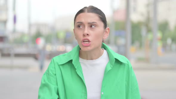 Portrait of Angry Hispanic Woman Fighting Outdoor