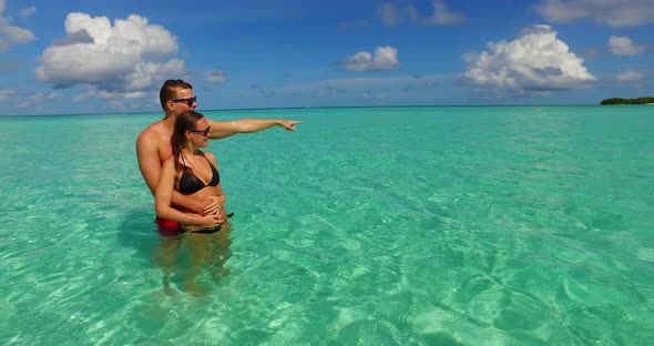 Young couple on romantic honeymoon enjoy life on beach on paradise white sand 4K background