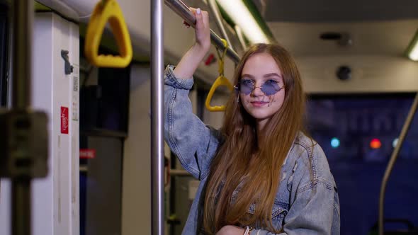 Attractive Woman in Public Tram Having Fun After Shopping with Bright Bags Traveling By Bus Home