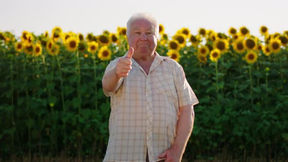 A Very Cute Looking Old Man is Showing the Thumbs