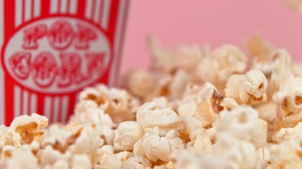Falling Popcorn in Super Slow Motion on Pink Background