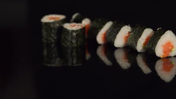 Row of Japanese Sushi on Black Background Closeup