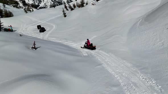 Snowmobile high in the mountains aerial view 4 K