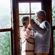Happy senior couple in love dance at home agains a big windows view with nature woods outside - VideoHive Item for Sale