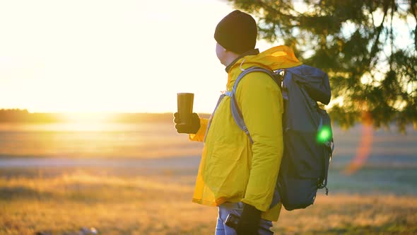 Hiker Young Tourist Enjoying Nature Drinking Hot Tea at Sunset