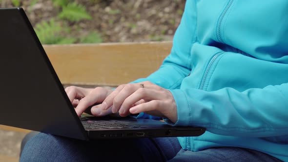 Young Woman Female Freelancer Working with Laptop with Beautiful View of Forest and Lake