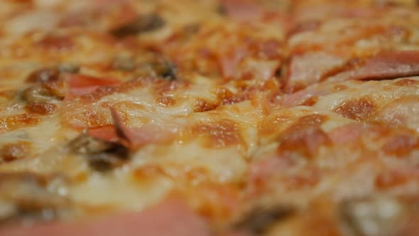 Italian cuisine pizza baked shallow DOF slow panning 4K 3840X2160 UHD video - Tasty pizza cutted on 