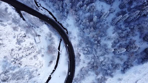 Snowy Mountains Winter Forest and Road with Cars