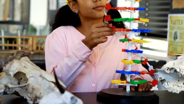 Schoolkid experimenting molecule model in laboratory 4k