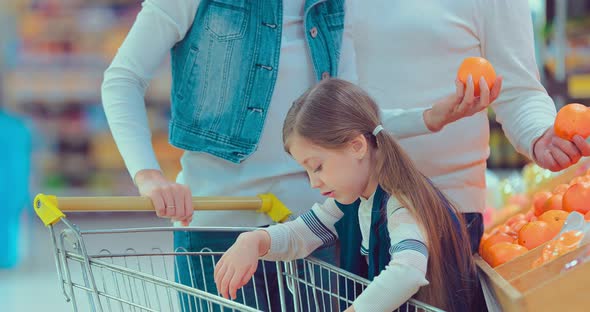 Little Girl is Buying Oranges