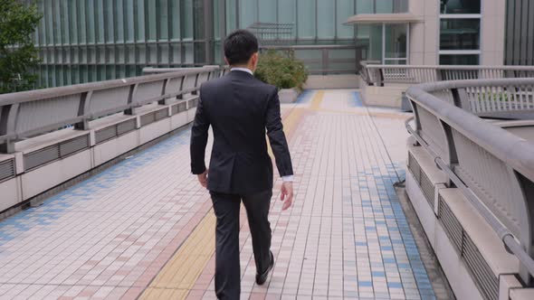 Japanese businessman walking in Tokyo