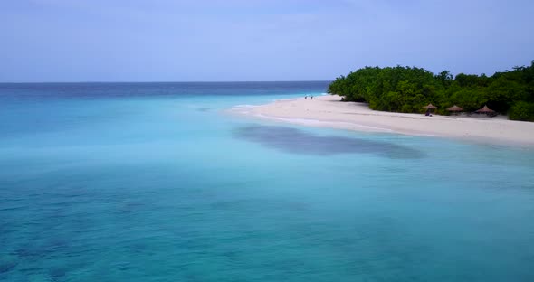 Tropical fly over tourism shot of a white sandy paradise beach and aqua turquoise water background i