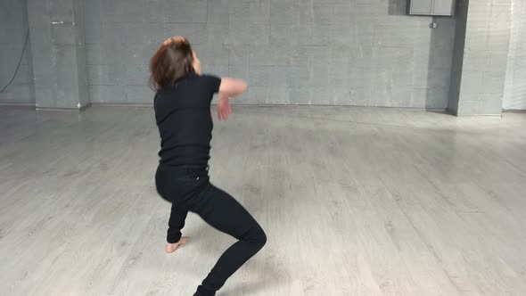 Young Woman Practicing Dance Element in Studio
