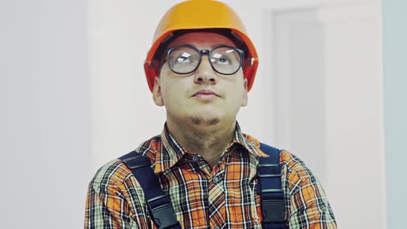 Portrait of Happy Young Architect in Helmet Standing with Crossed Arms