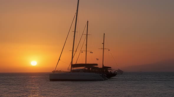 Sunset in Mykonos, Greece, with Cruise Ships and Yachts in the Harbor