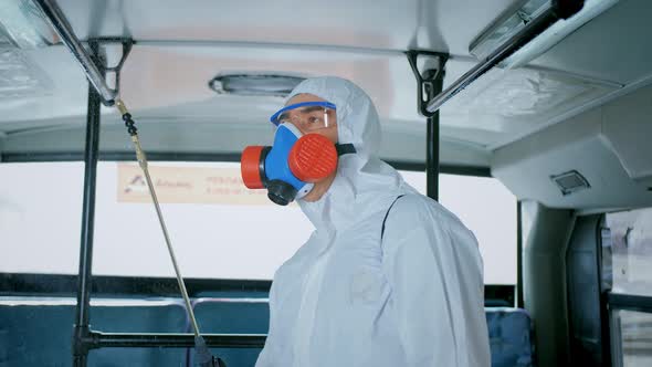 Disinfector in Protective Suit, Disinfection Inside Public Urban Transport, Bus alt