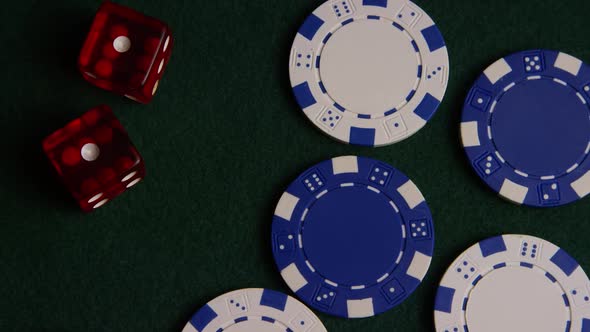 Rotating shot of poker cards and poker chips on a green felt surface - POKER 039