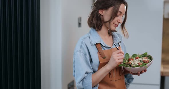 Housewife with Healthy Salad on the Kitchen