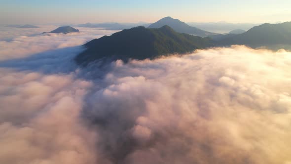 Aerial view of sunrise with fog above mountains