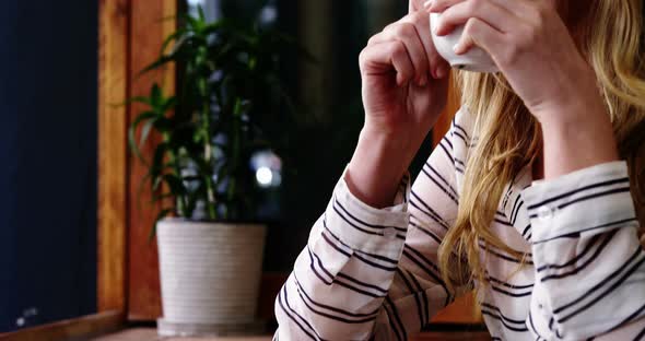 Woman having coffee in cafe