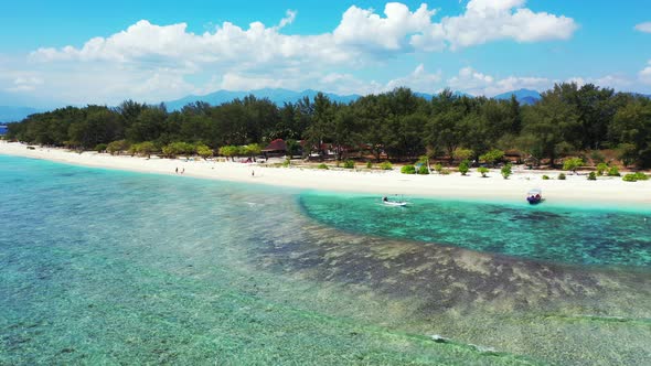 Daytime flying copy space shot of a white sand paradise beach and turquoise sea background in hi res