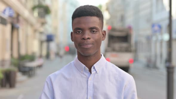 Portrait of African Man Showing Ok Sign with Hand Outdoor