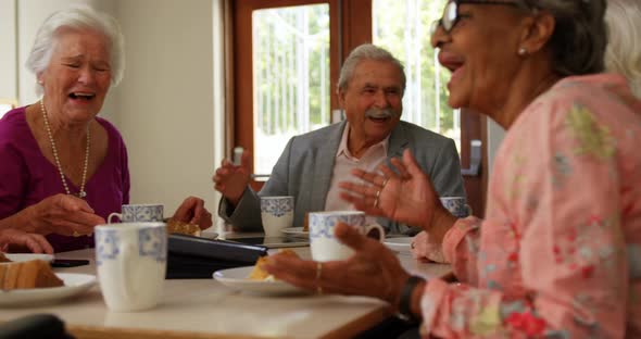 Group of Mixed-race senior friends eating breakfast on dining table 4k