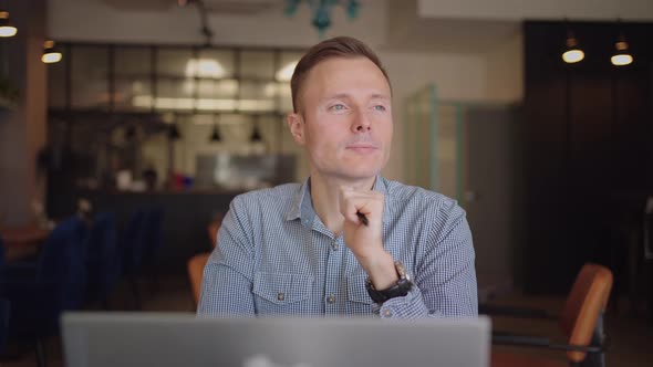 Thoughtful Serious Young Man Student Writer Sit at Home Office Desk with Laptop Thinking of